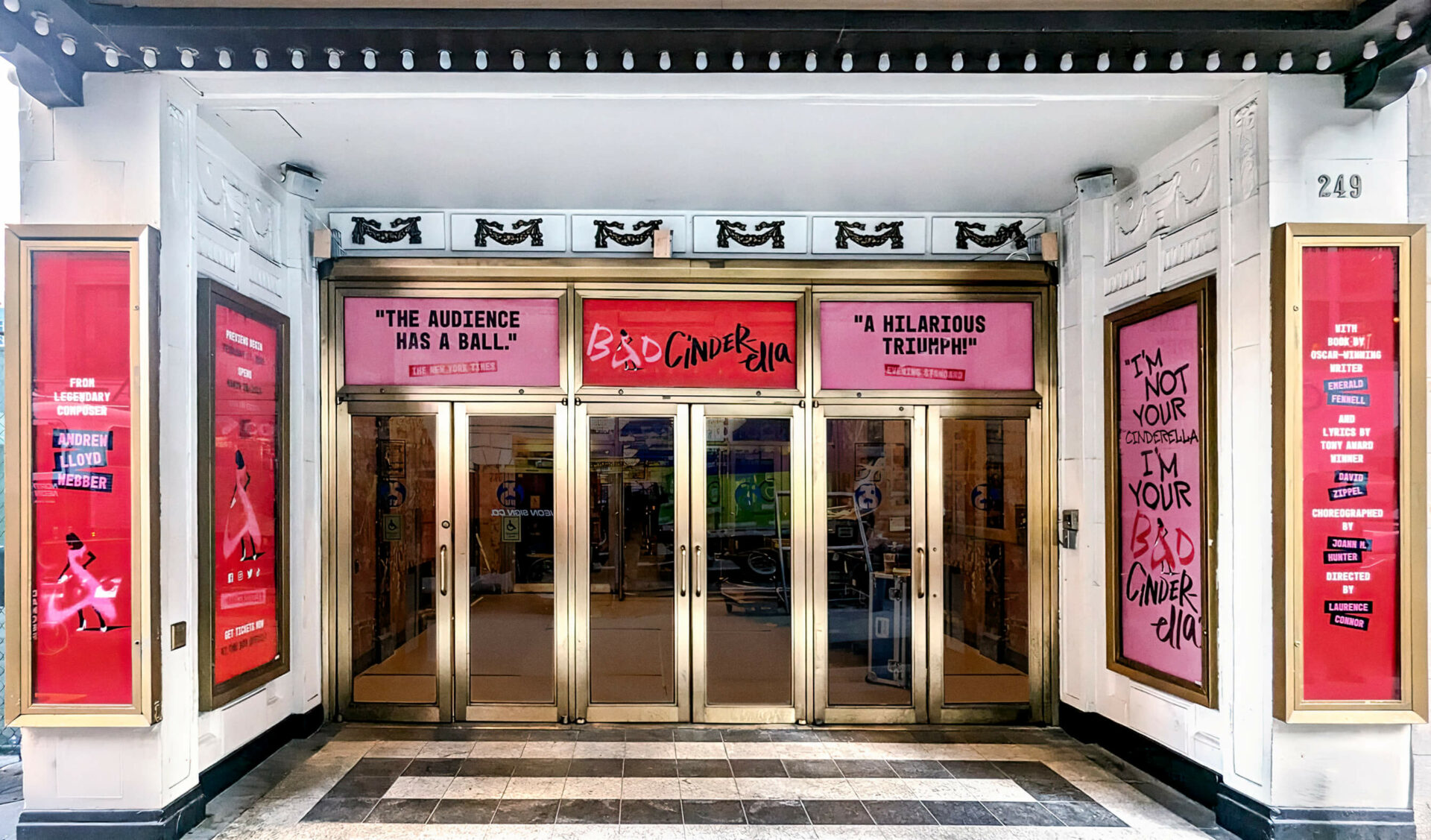Theater entrance decorated with posters and slogans for the Bad Cinderella musical.