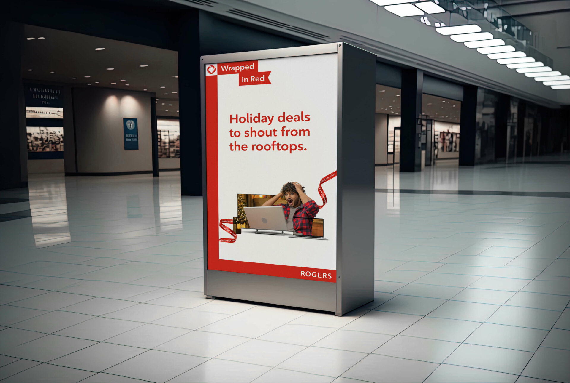 Rogers “Wrapped in red” campaign OOH inside a shopping mall promoting holiday deals.