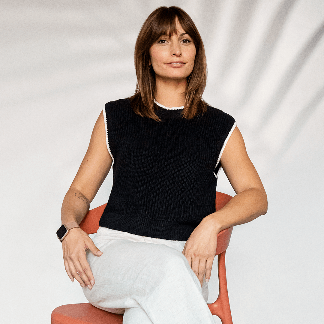 Picture of Chloé Lorini sitting in an orange chair.