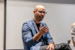 Portrait of Nuno Bamberg speaking to the audience.
