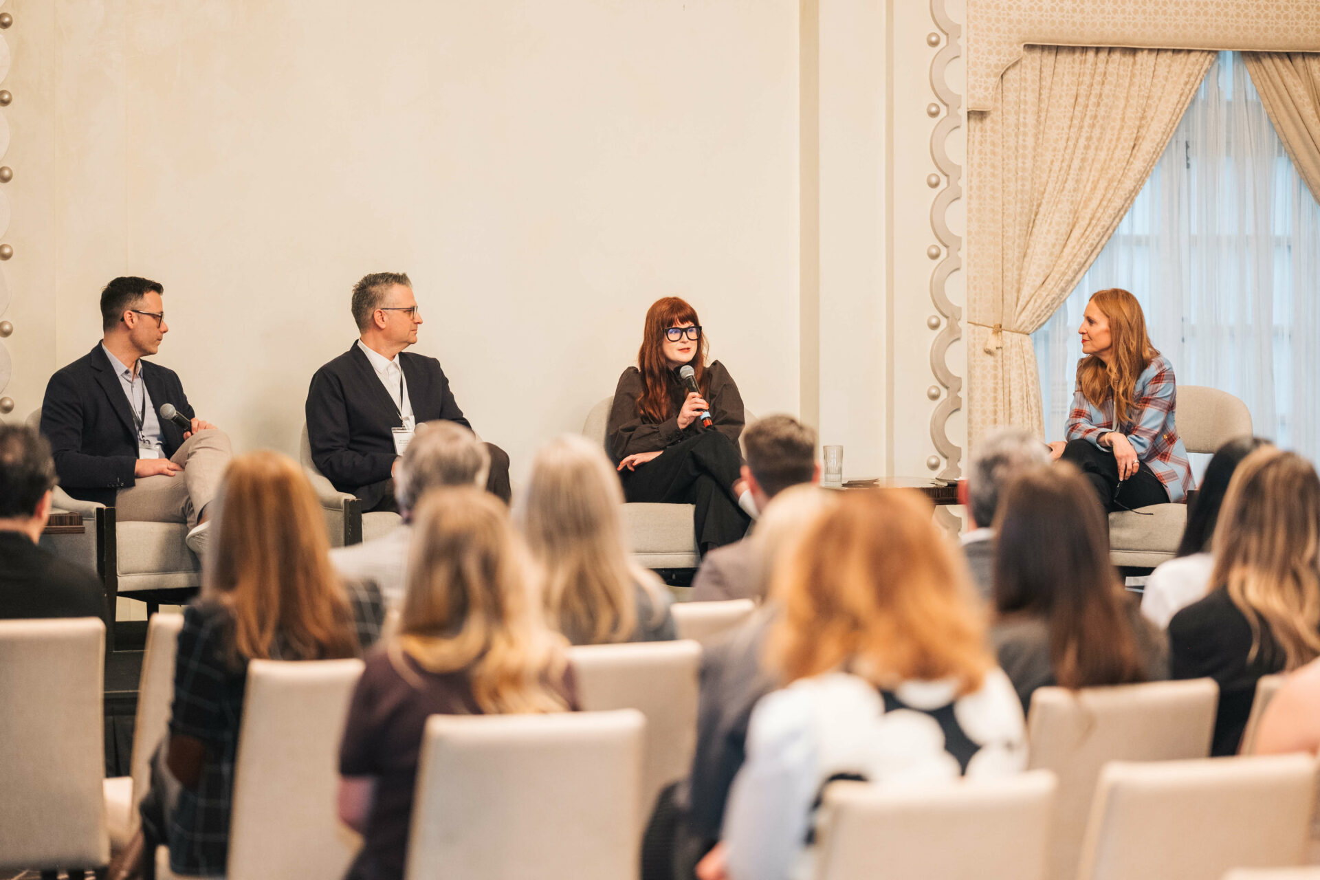 Panelists speak on stage at the Vancouver C-Suite Marketing Summit during the CMO panel