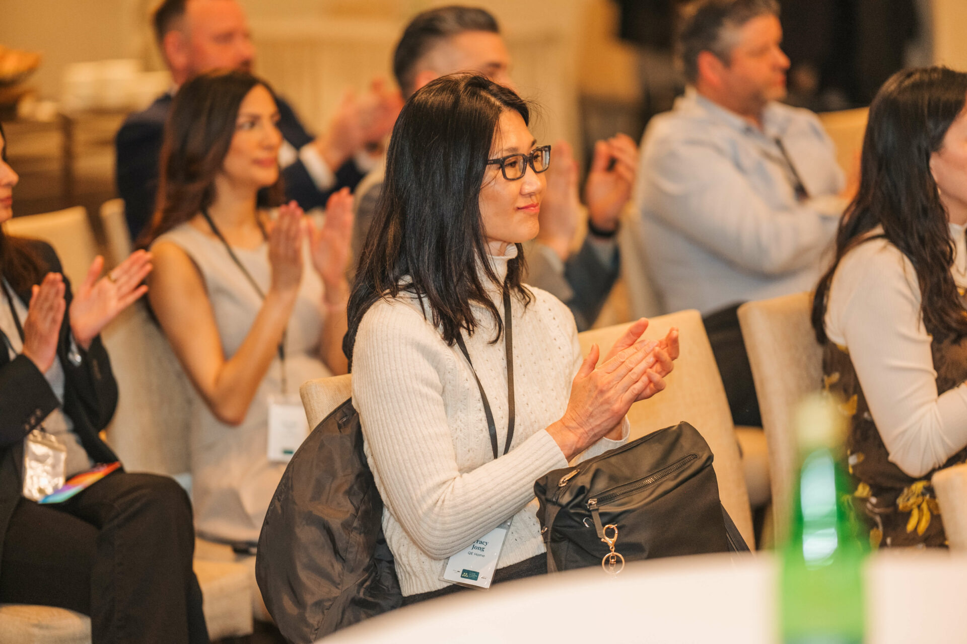 Audience members applaud during the Vancouver C-Suite Marketing Summit after a live panel session.