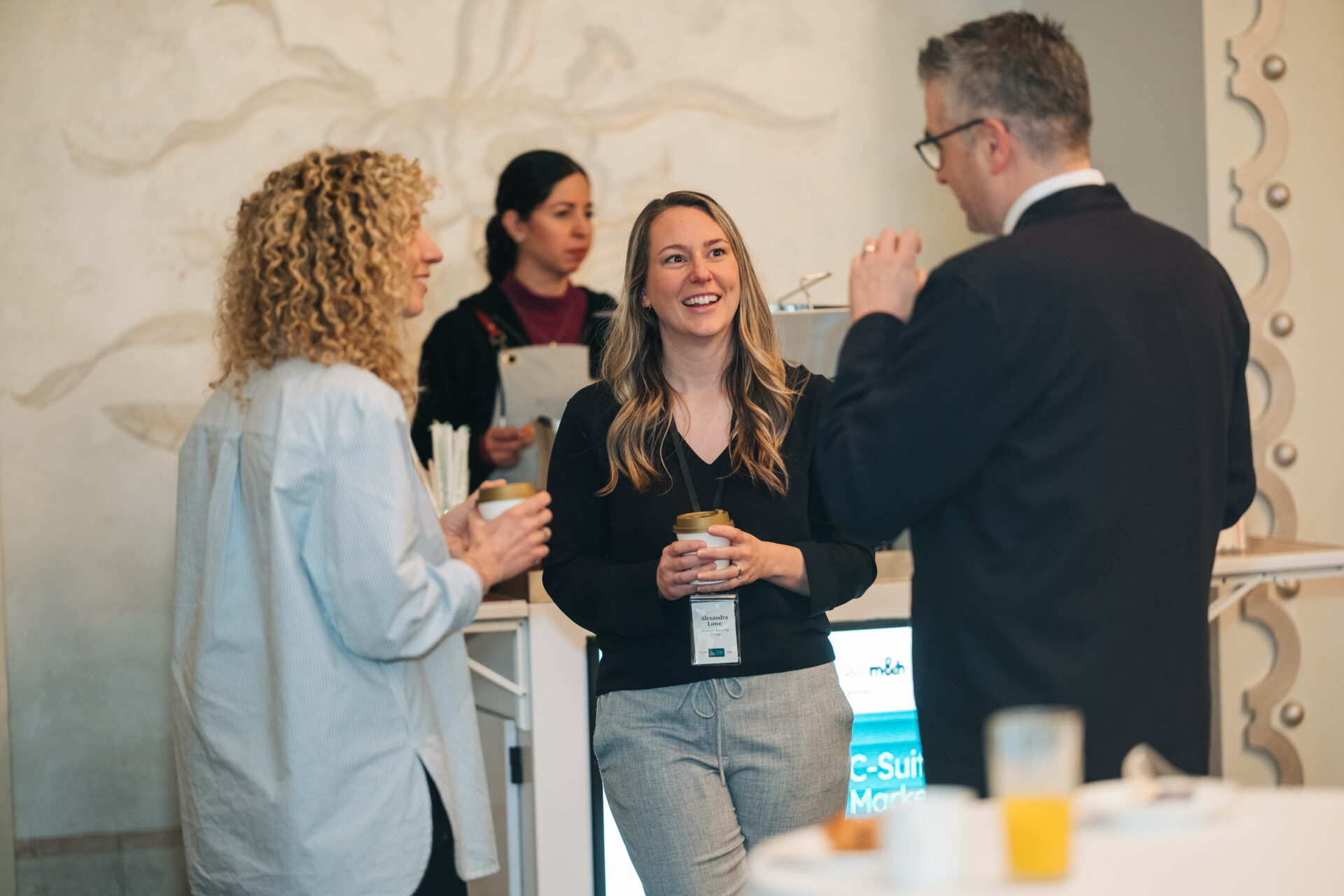 Attendees connect over coffee during a networking break at the Vancouver C-Suite Marketing Summit.