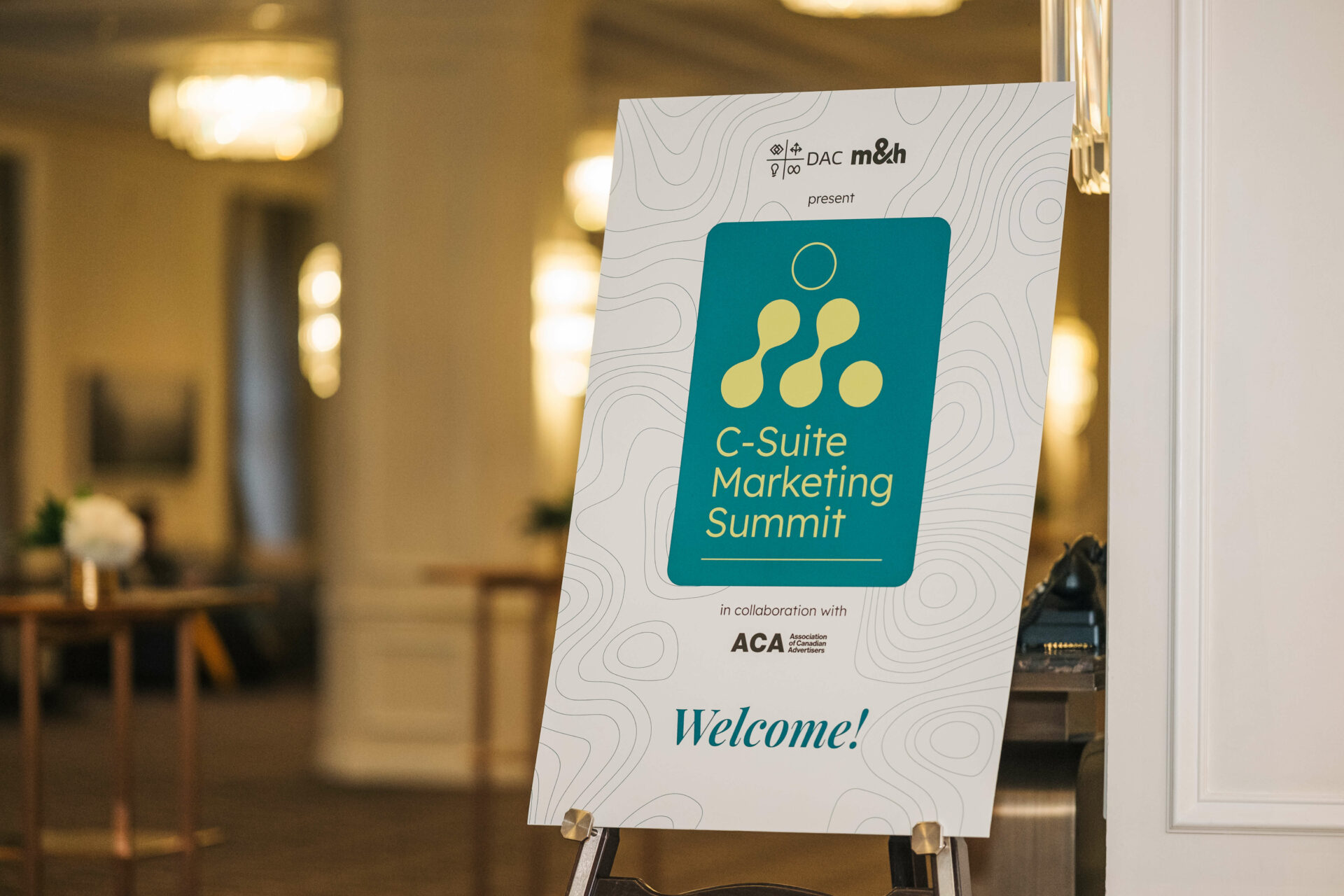 Welcome signage for the Vancouver C-Suite Marketing Summit, featuring event branding at the venue entrance.