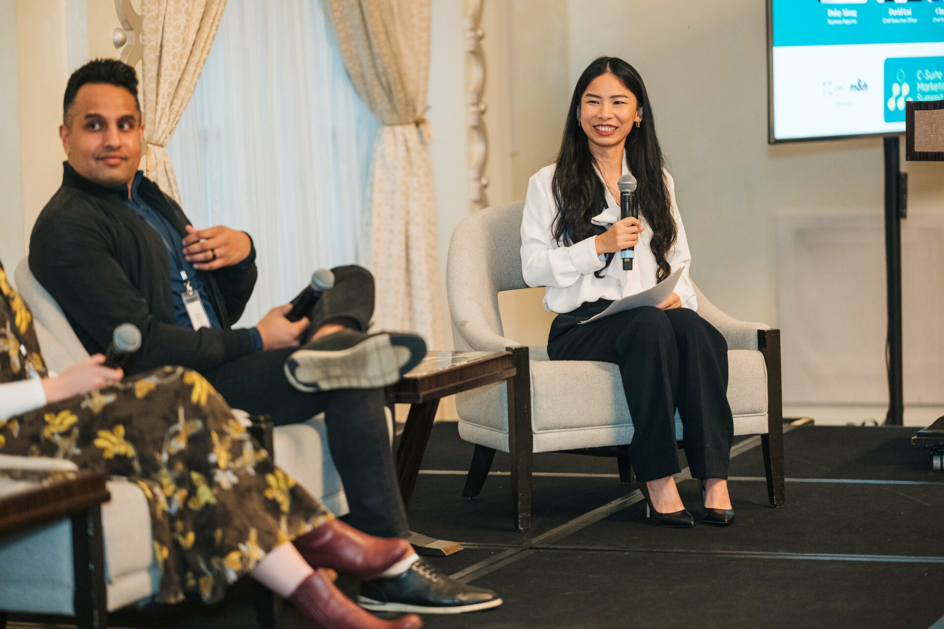 Daisy Xiong and Manoj Jasra from the CEO panel at the Vancouver C-Suite Marketing Summit, sharing insights on stage.