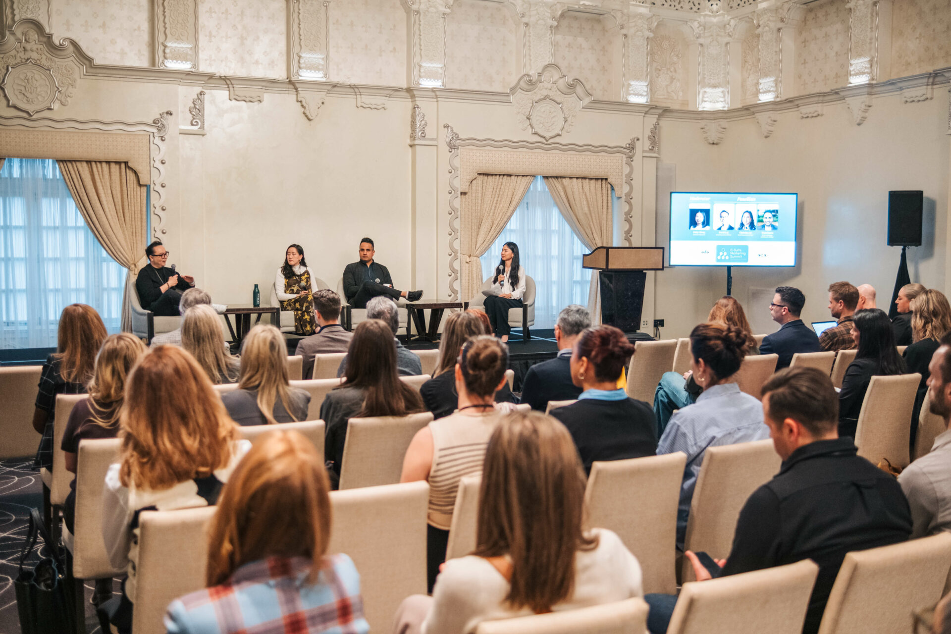 Side view of the CEO panel discussion at the Vancouver C-Suite Marketing Summit with an engaged audience.