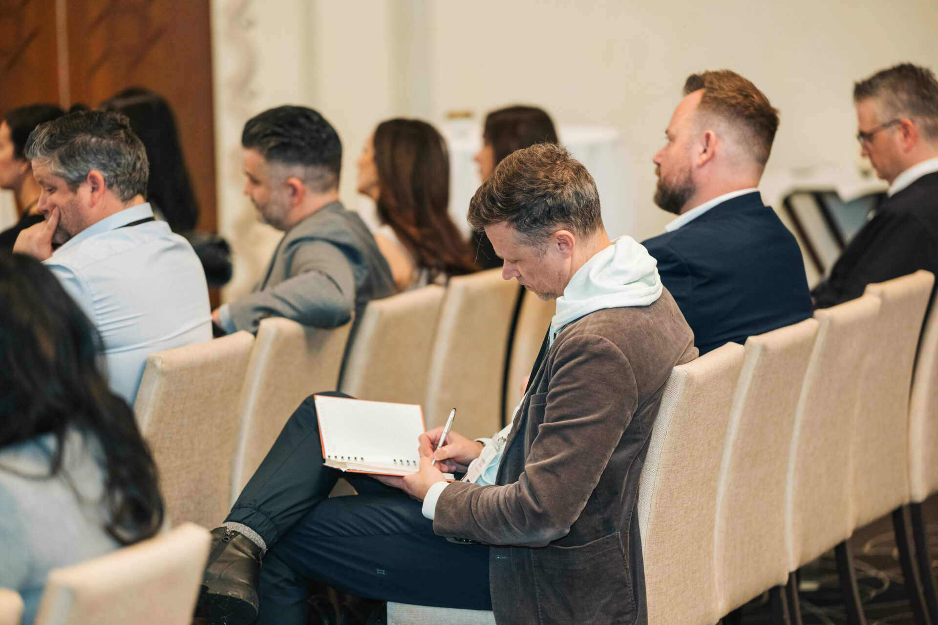 An attendee takes notes during a session at the Vancouver C-Suite Marketing Summit.
